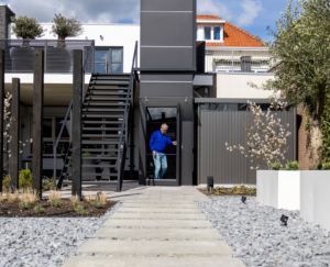 man using outdoor elevator in his home