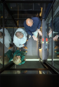 three people in elevator