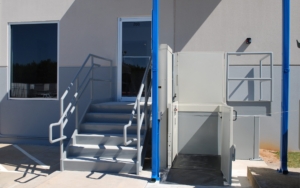Accessible elevator entrance with stairs and wheelchair lift for safety and convenience.