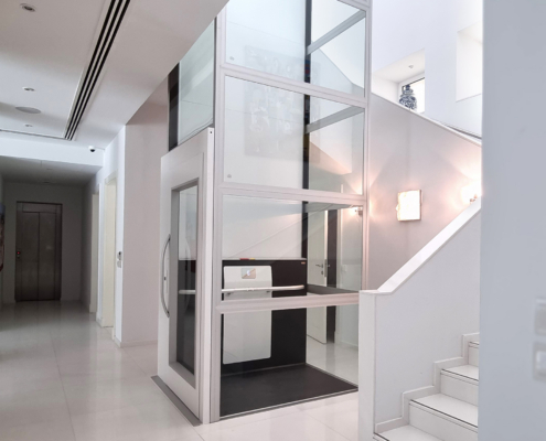 Homeowner comparing shafted and shaftless home elevator options
